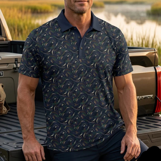 Man wearing a patterned polo shirt sitting on a truck bed with a natural background